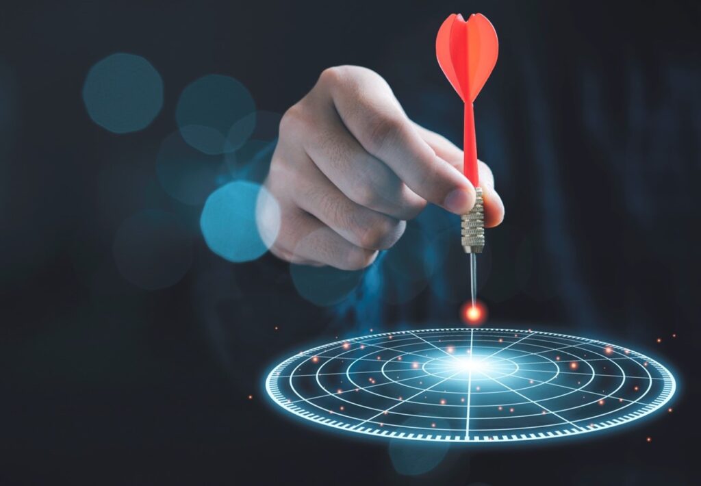 businessman throwing a red arrow dart to virtual target